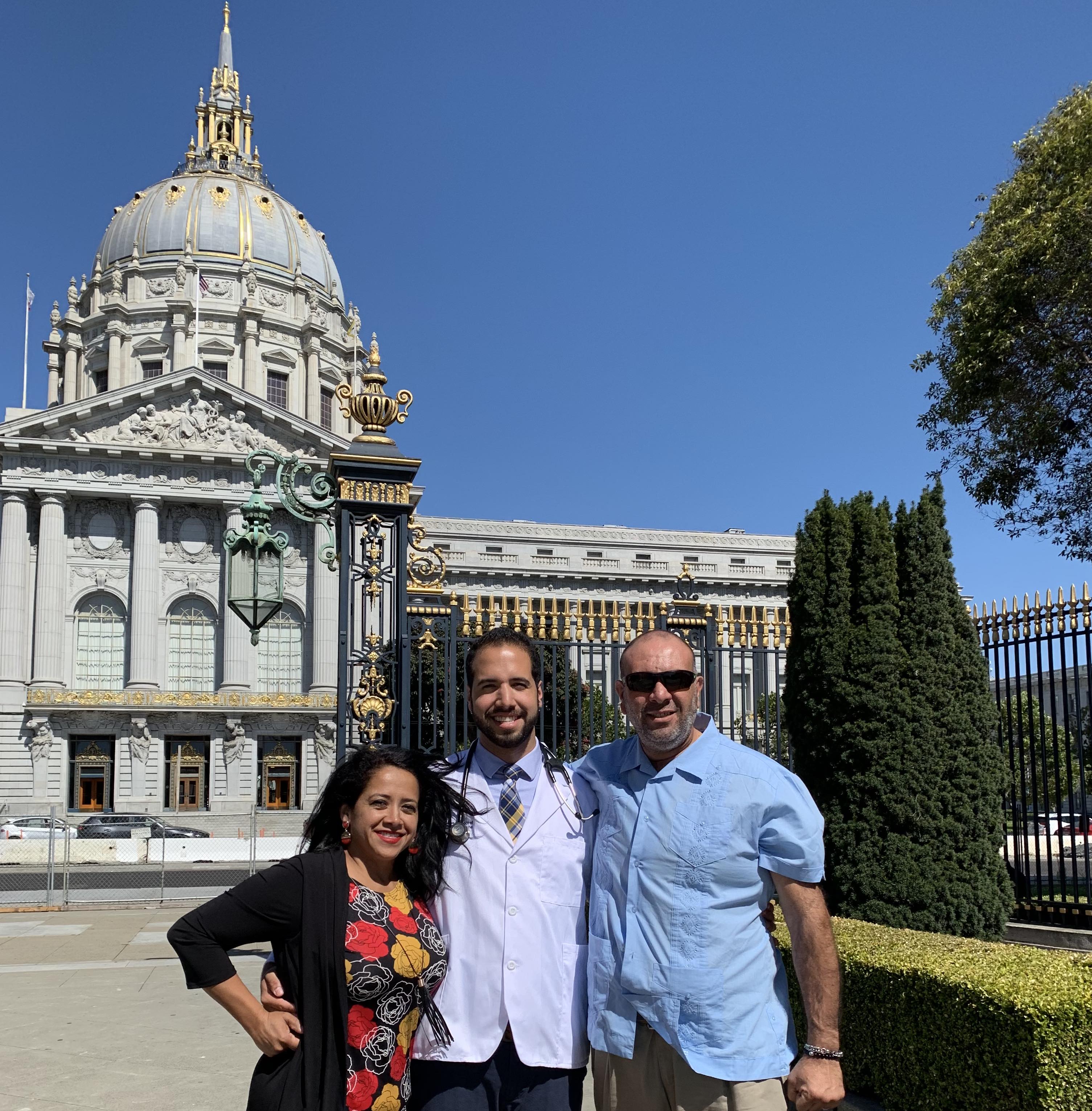 Photograph of Ernesto Rojas and family in front of government building