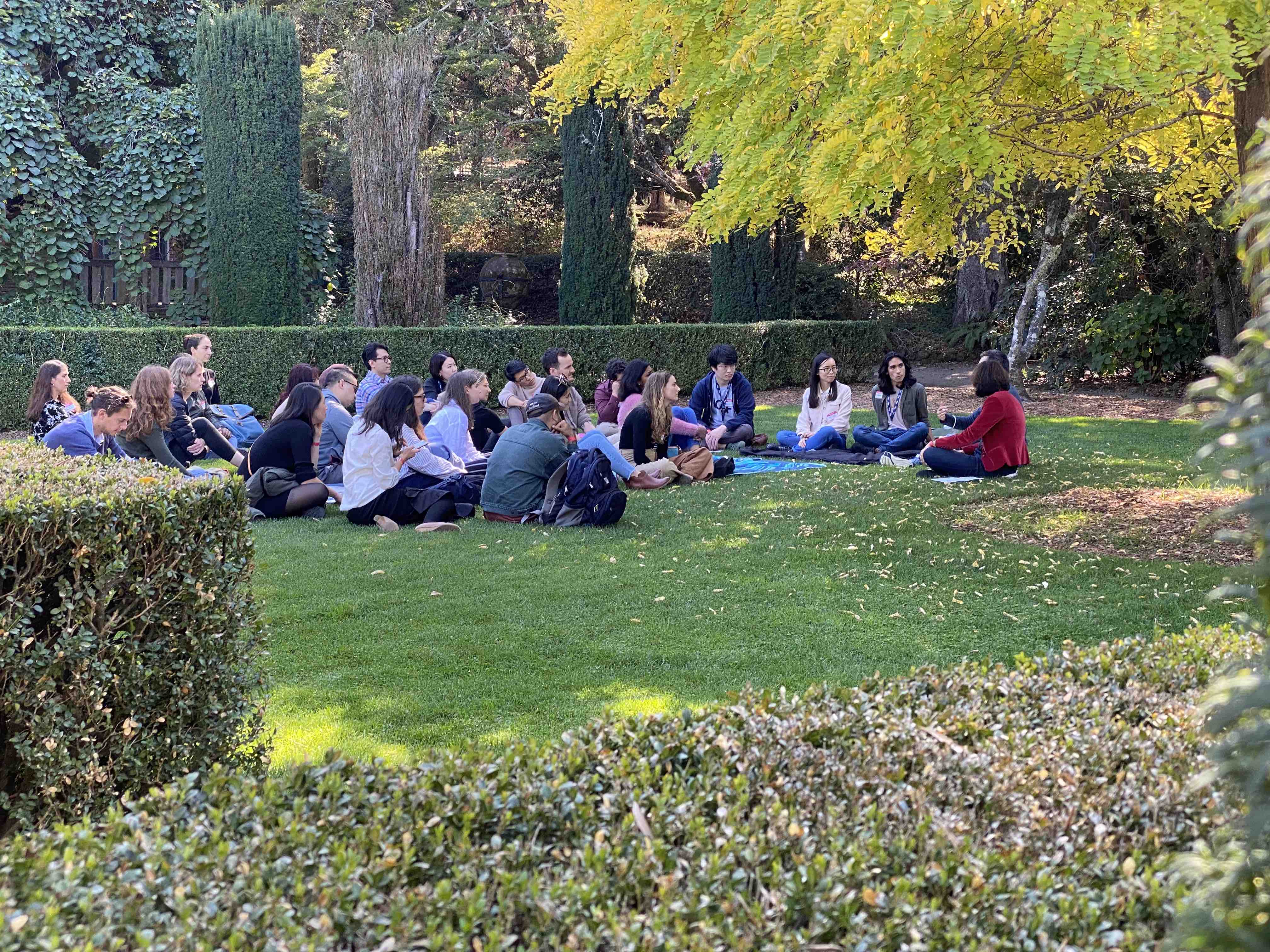 Group gathered in grass sitting on blankets for UCSF Broad Stem Cell Center Retreat breakout session with Ed Hsaio and Tippi MacKenzie